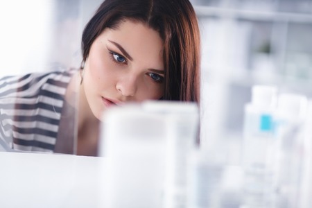 Beautiful young woman in shopの写真素材