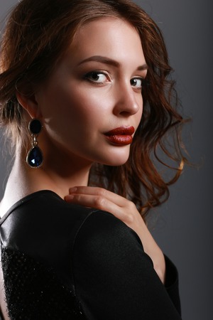 Portrait of beautiful brunette woman in black dress.の写真素材