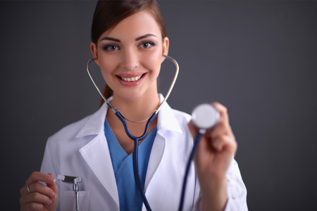 Doctor listening with a stethoscope, close-up, isolated on whitの写真素材