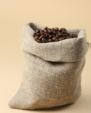 Coffee beans spilled out of the bagの写真素材