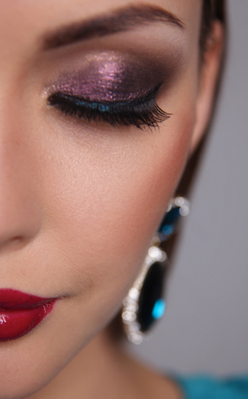 Portrait of beautiful young brunette woman in ear-ringsの写真素材