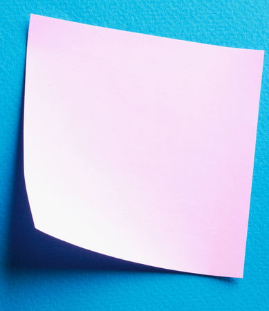 Pink paper note on blue backgroundの写真素材