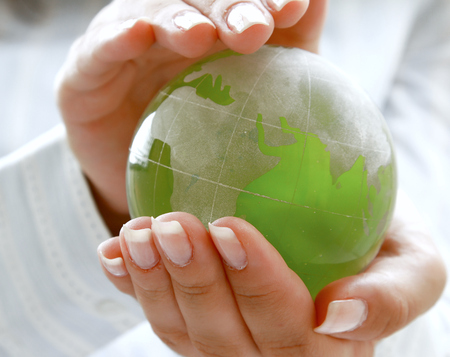 Hands holding a green earthの写真素材