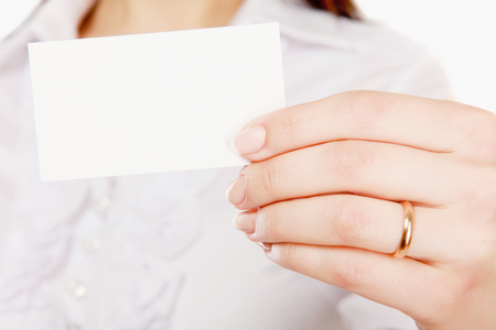 Businesswoman showing and handing a blank business cardの写真素材