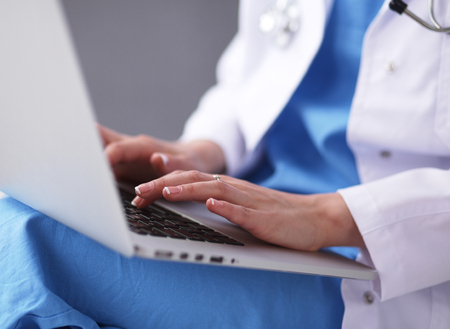 Female doctor working isolated on grey  backgroundの写真素材
