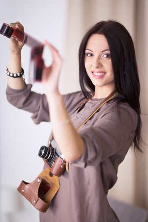 Woman is a proffessional photographer with cameraの写真素材