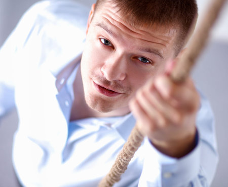 Image of businessman ascending up the rope