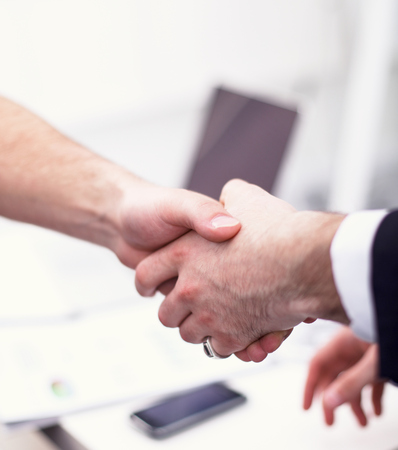 Business people handshake, sitting in the officeの写真素材