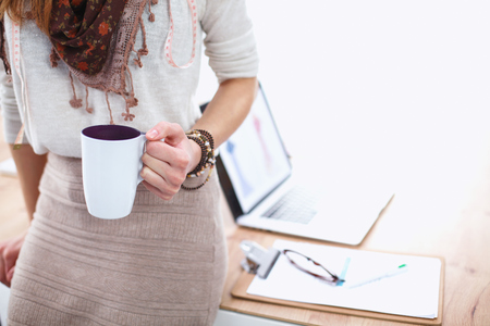 Closeup young woman holding cup of coffeeの写真素材