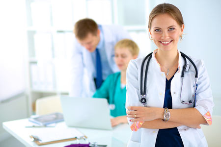 Woman doctor standing with stethoscope at hospitalの写真素材