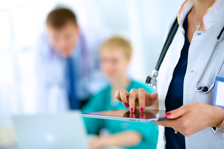 Young woman  doctor holding a tablet pcの写真素材