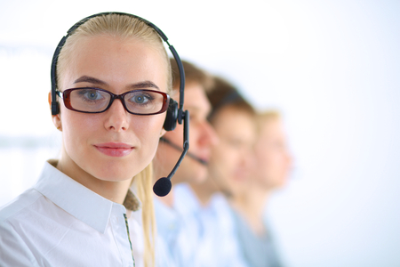 Attractive positive young business people and colleagues in a call center officeの写真素材