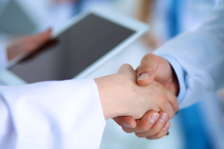 Young medical people handshaking at officeの写真素材