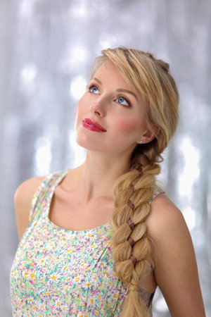 Beautiful blonde young woman with braid hairdo