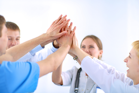 Doctors and nurses in a medical team stacking handsの写真素材