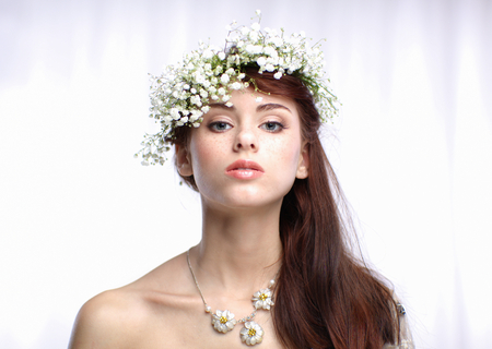 Portrait of a beautiful woman with flowers in her hairの写真素材