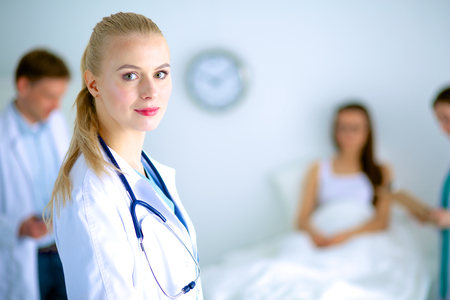 Woman doctor standing with folder at hospitalの写真素材