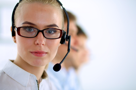 Attractive positive young businesspeople and colleagues in a call center officeの写真素材