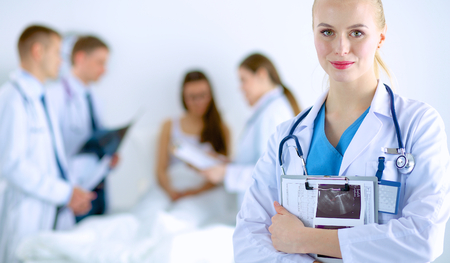 Woman doctor standing with stethoscope at hospitalの写真素材