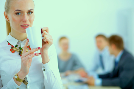 Portrait of a young woman working at office standingの写真素材