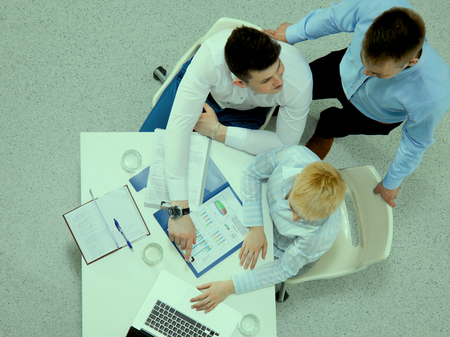 Business people sitting and discussing at business meeting, in officeの写真素材