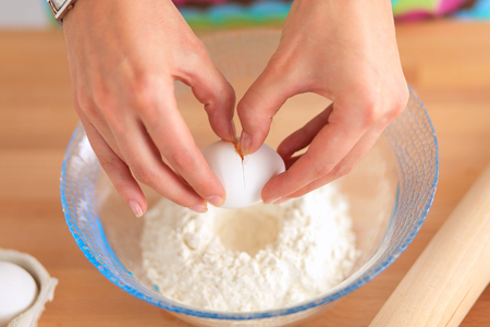 Woman is making cakes in the kitchenの写真素材