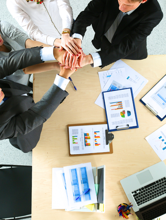 Business team with hands together - teamwork concepts, isolatedの写真素材