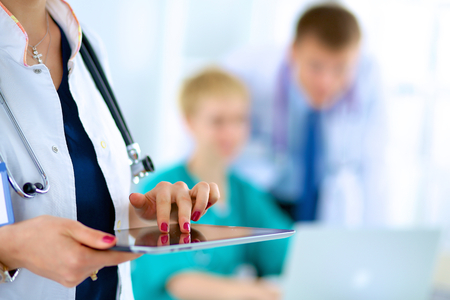 Young woman  doctor holding a tablet pc .の写真素材
