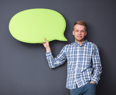 Man holding white blank speech bubble with space for text .の写真素材
