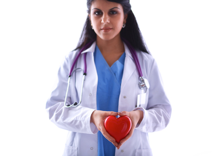 Female doctor with stethoscope holding heart, isolated on white backgroundの写真素材
