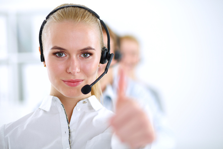 A smiling customer service girl showing ok, isolated on white backgroundの写真素材