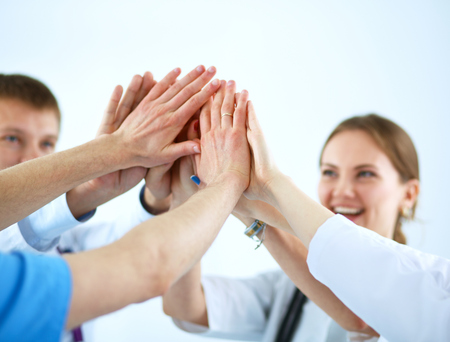 Doctors and nurses in a medical team stacking hands  .