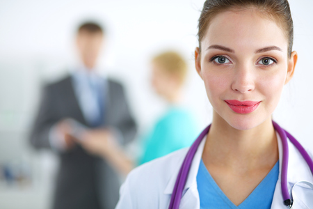 Woman doctor standing with stethoscope at hospital .の写真素材