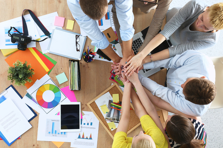 Business team with hands together - teamwork concepts, isolatedの写真素材