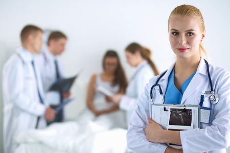 Woman doctor standing with folder at hospital .の写真素材