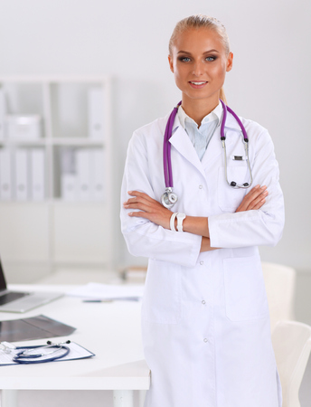 Portrait of young woman doctor with white coat standingの写真素材