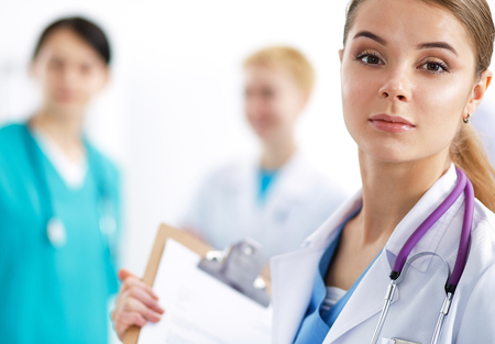 Woman doctor standing with folder at hospital .の写真素材