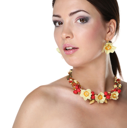Portrait of young beautiful brunette woman in beads .の写真素材