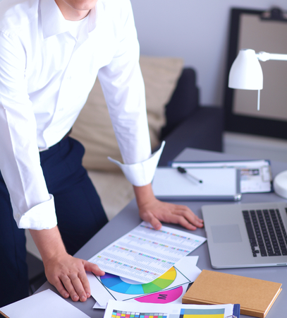 Young businessman working in office, sitting at desk .の写真素材