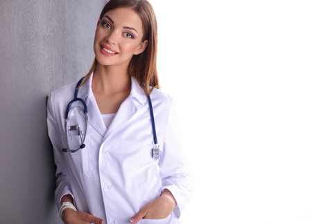 Young doctor woman with stethoscope isolated on grey backgroundの写真素材
