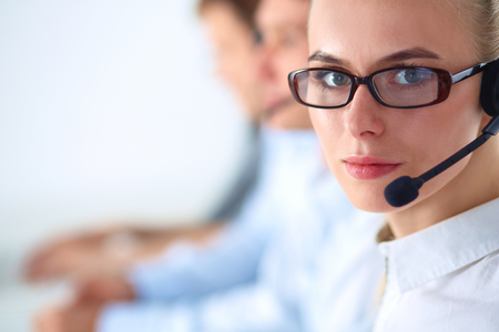Attractive positive young businesspeople and colleagues in a call center office.の写真素材