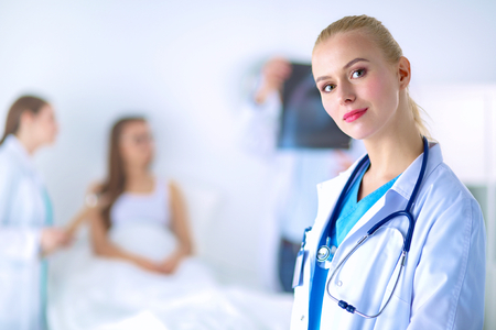 Woman doctor standing with stethoscope at hospital .の写真素材