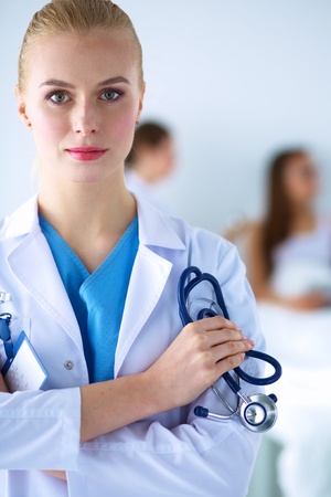 Woman doctor standing with stethoscope at hospital .の写真素材
