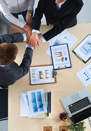 Business team with hands together - teamwork concepts, isolatedの写真素材
