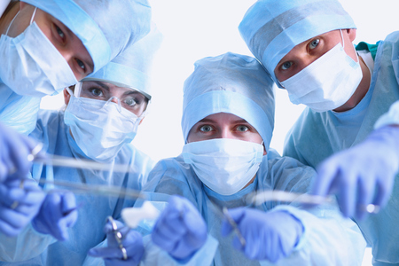 Below view of surgeons holding medical instruments in hands .の写真素材