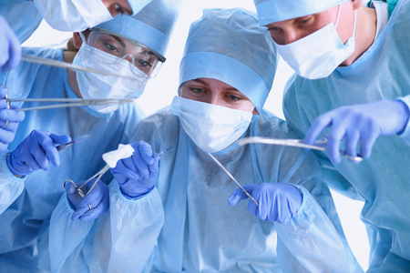 Below view of surgeons holding medical instruments in hands .の写真素材