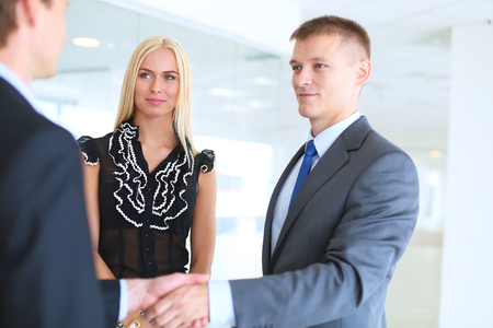Businesswoman Shaking Hands In Officeの写真素材