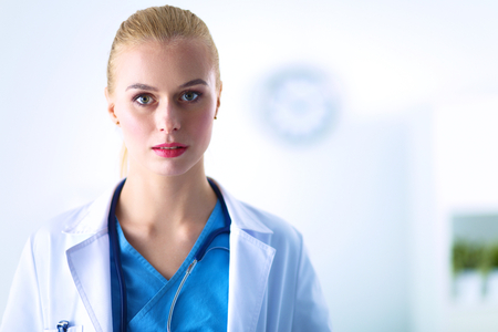 Woman doctor standing with stethoscope at hospital .の写真素材