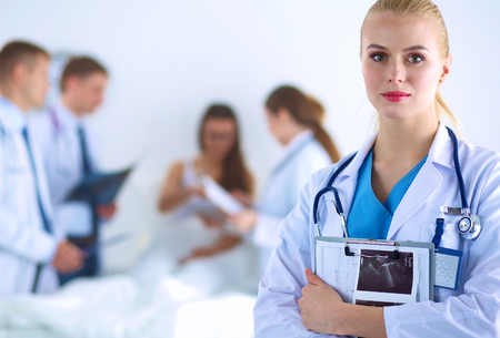 Woman doctor standing with stethoscope at hospital .の写真素材