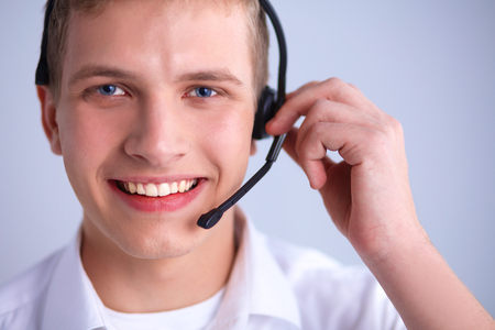 Call center male operator on gray backgroundの写真素材